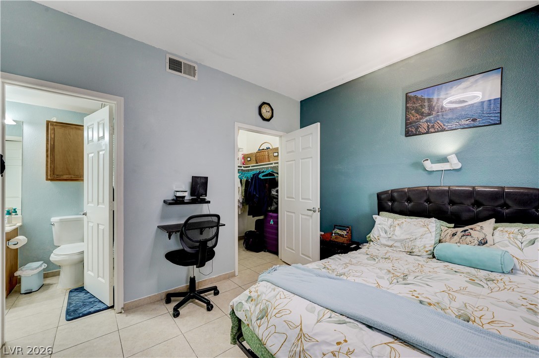 8555 West Russell Road, Unit 1017 Las Vegas, NV 89113 - Photo 12 of 34 Well-lit sleeping quarters offering direct access to a private full bathroom and a generous walk-in closet.