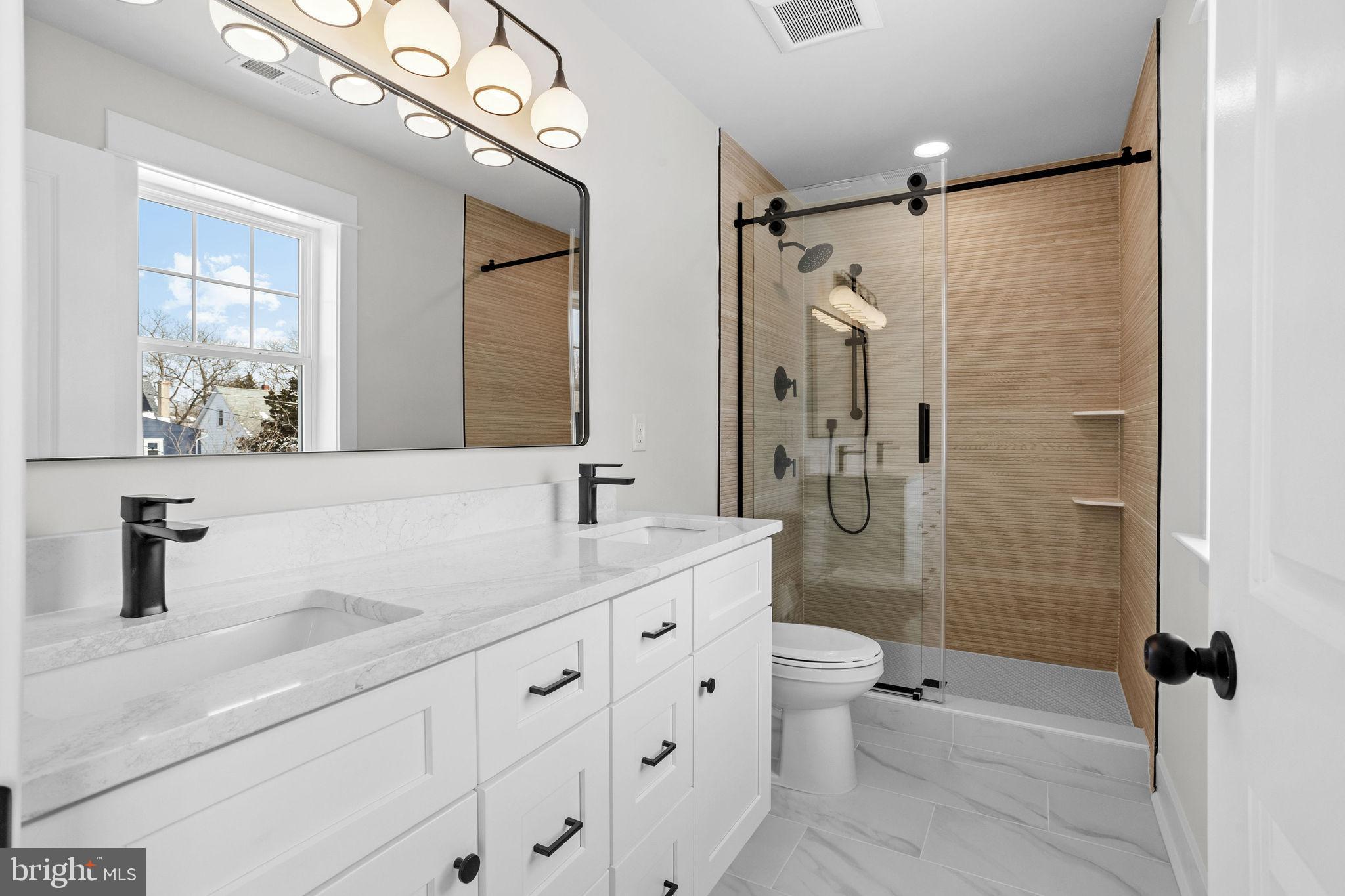 406 Midway Riverton, NJ 08077 - Photo 23 of 30 a bathroom with a double vanity sink mirror and shower