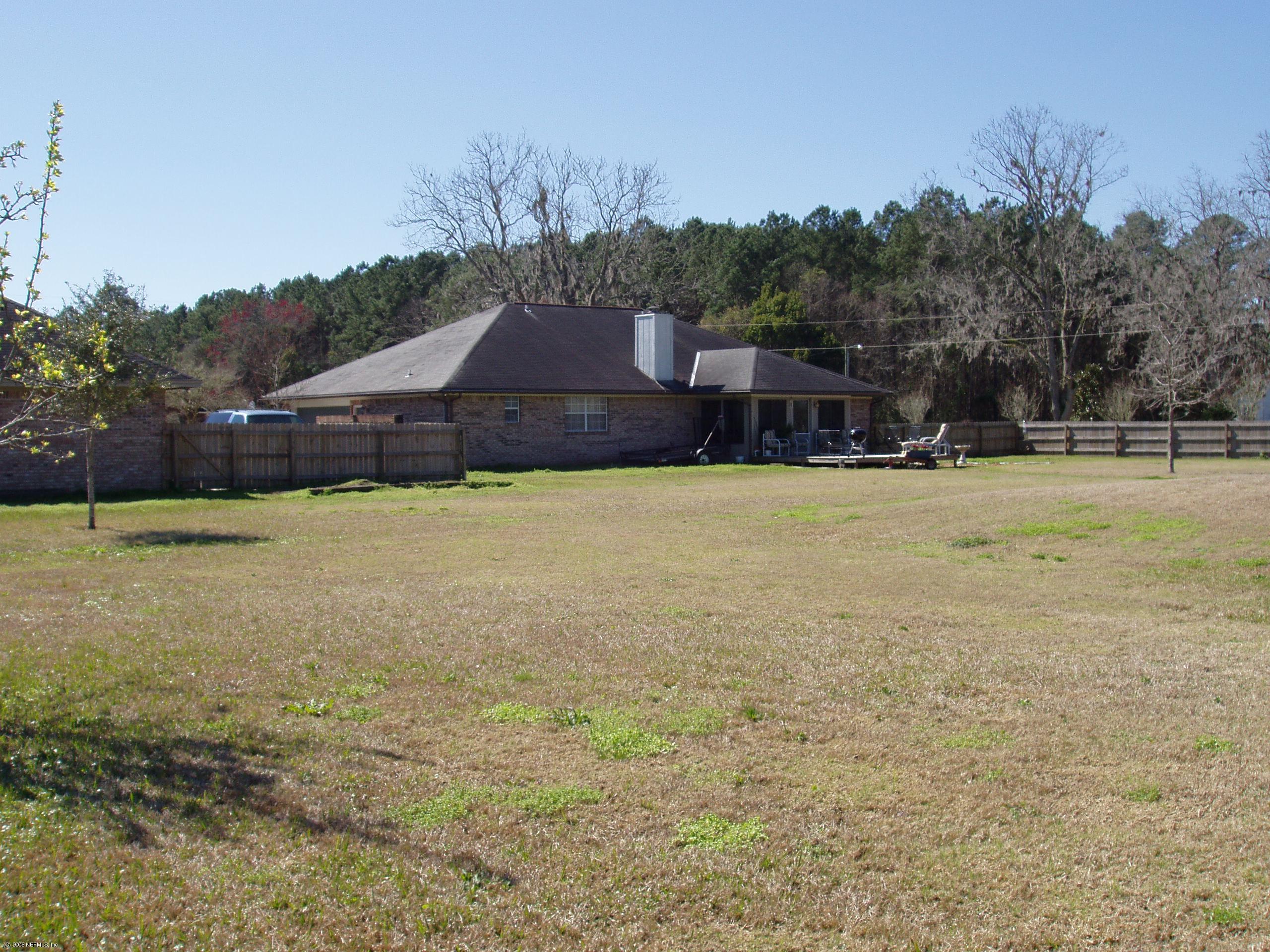 45245 Stratton Road Callahan, FL 32011 - Photo 1 of 2 a swimming pool is sitting in the middle of a yard