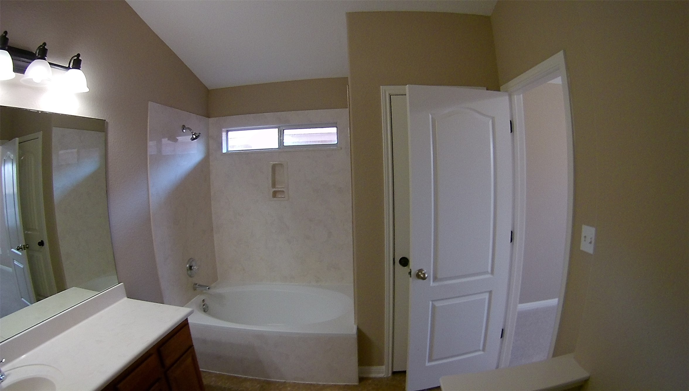 3304 Wickham Lane Austin, TX 78725 - Photo 5 of 13 Bathroom with vanity, shower / washtub combination, and lofted ceiling