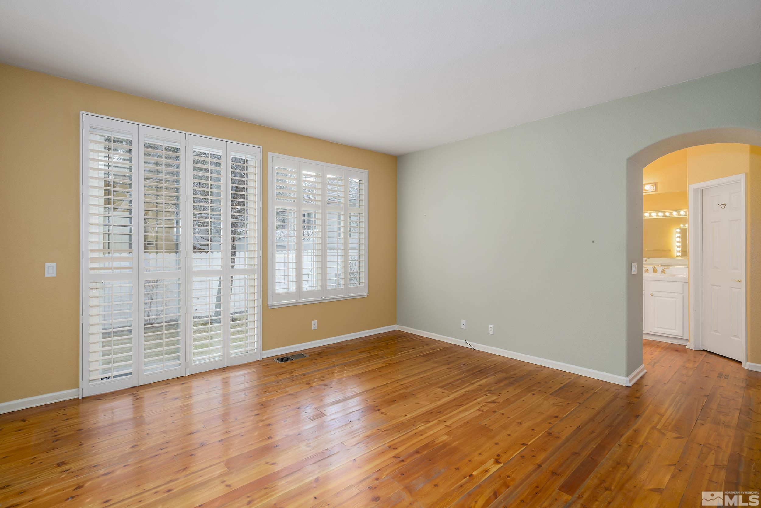 1270 Greenwich Way Reno, NV 89519 - Photo 14 of 20 a view of an empty room with wooden floor and a window