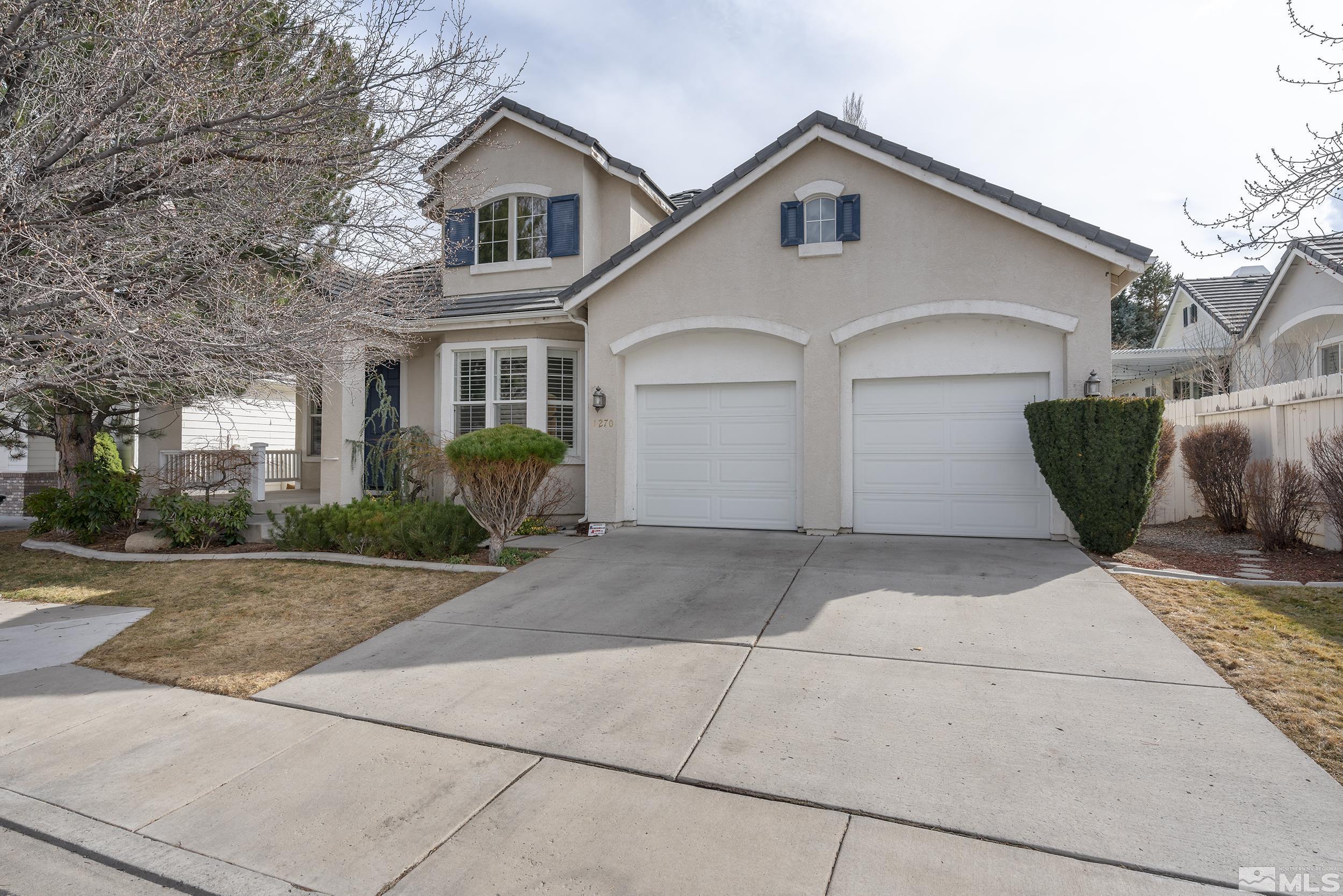 1270 Greenwich Way Reno, NV 89519 - Photo 2 of 20 a view of a white house with a yard and potted plants