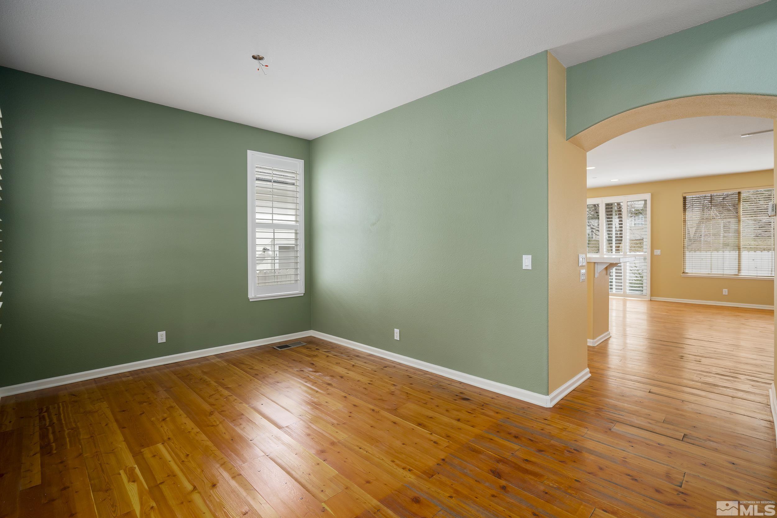 1270 Greenwich Way Reno, NV 89519 - Photo 7 of 20 an empty room with wooden floor and windows