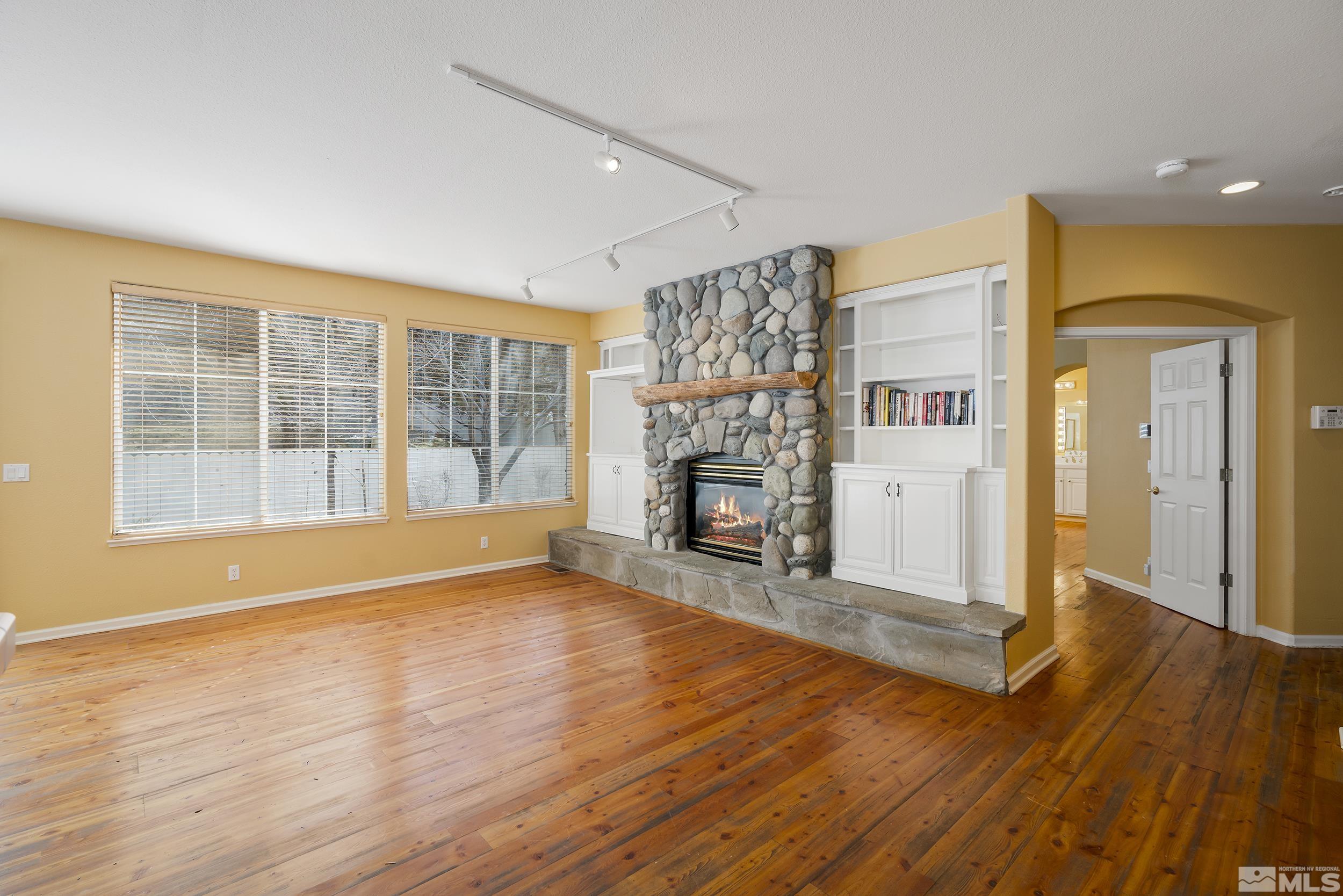 1270 Greenwich Way Reno, NV 89519 - Photo 8 of 20 a view of empty room with wooden floor and fireplace