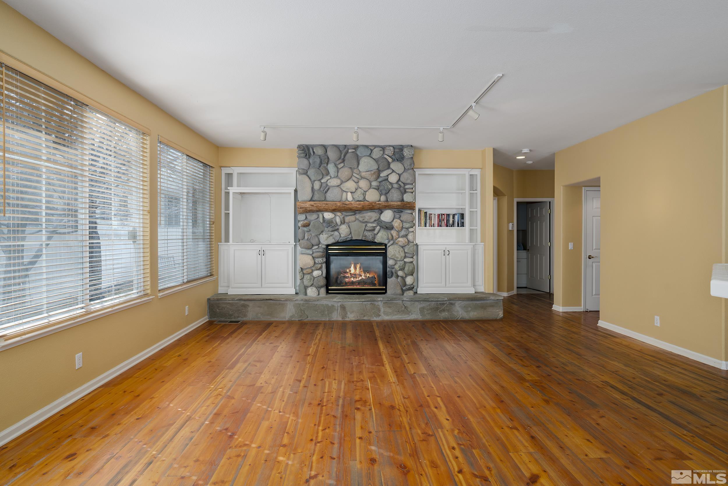 1270 Greenwich Way Reno, NV 89519 - Photo 9 of 20 a view of empty room with wooden floor and fireplace