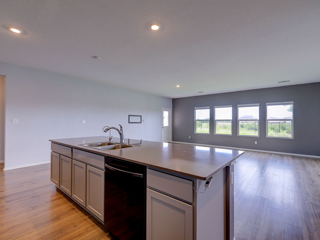 1716 Frontenac Street Leander, TX 78641 - Photo 10 of 34 a kitchen with a sink and stove