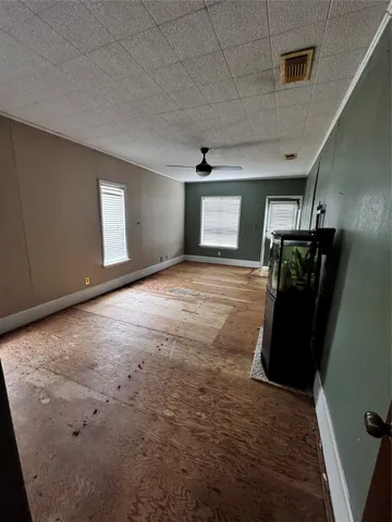 a kitchen with stainless steel appliances kitchen island granite countertop a table chairs and a refrigerator