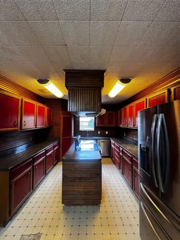 a kitchen with stainless steel appliances kitchen island granite countertop a stove a sink and dishwasher a oven with granite countertops