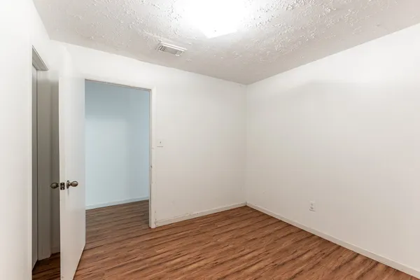 a view of a room with wooden floor