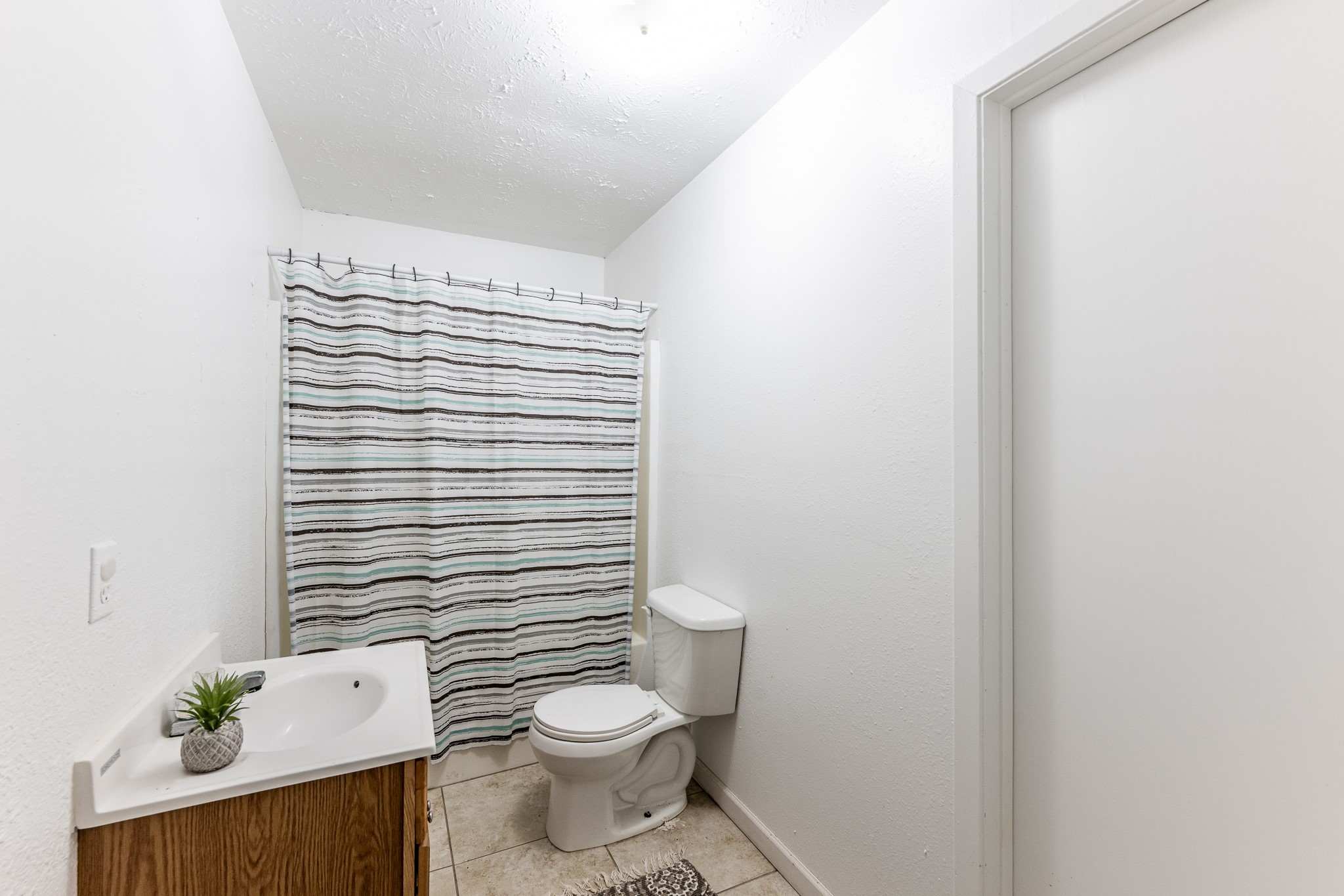 20471 Roy Hall Road Bedias, TX 77831 - Photo 14 of 24 a white toilet sitting next to a white cabinet