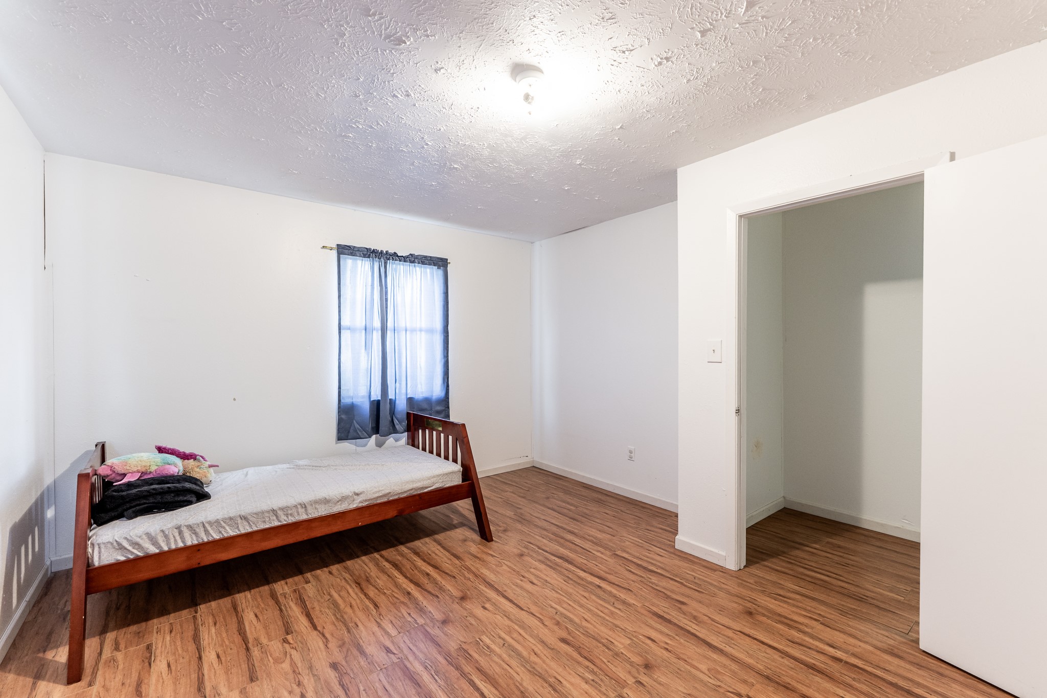 20471 Roy Hall Road Bedias, TX 77831 - Photo 15 of 24 a bedroom with bed and window