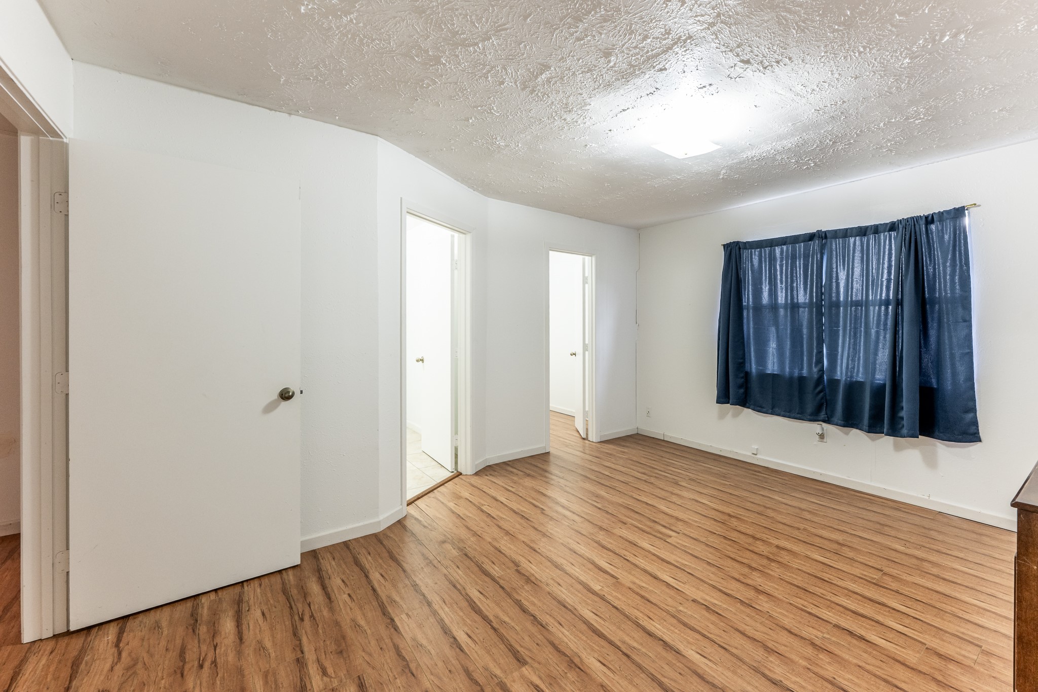 20471 Roy Hall Road Bedias, TX 77831 - Photo 16 of 24 a view of an empty room with wooden floor