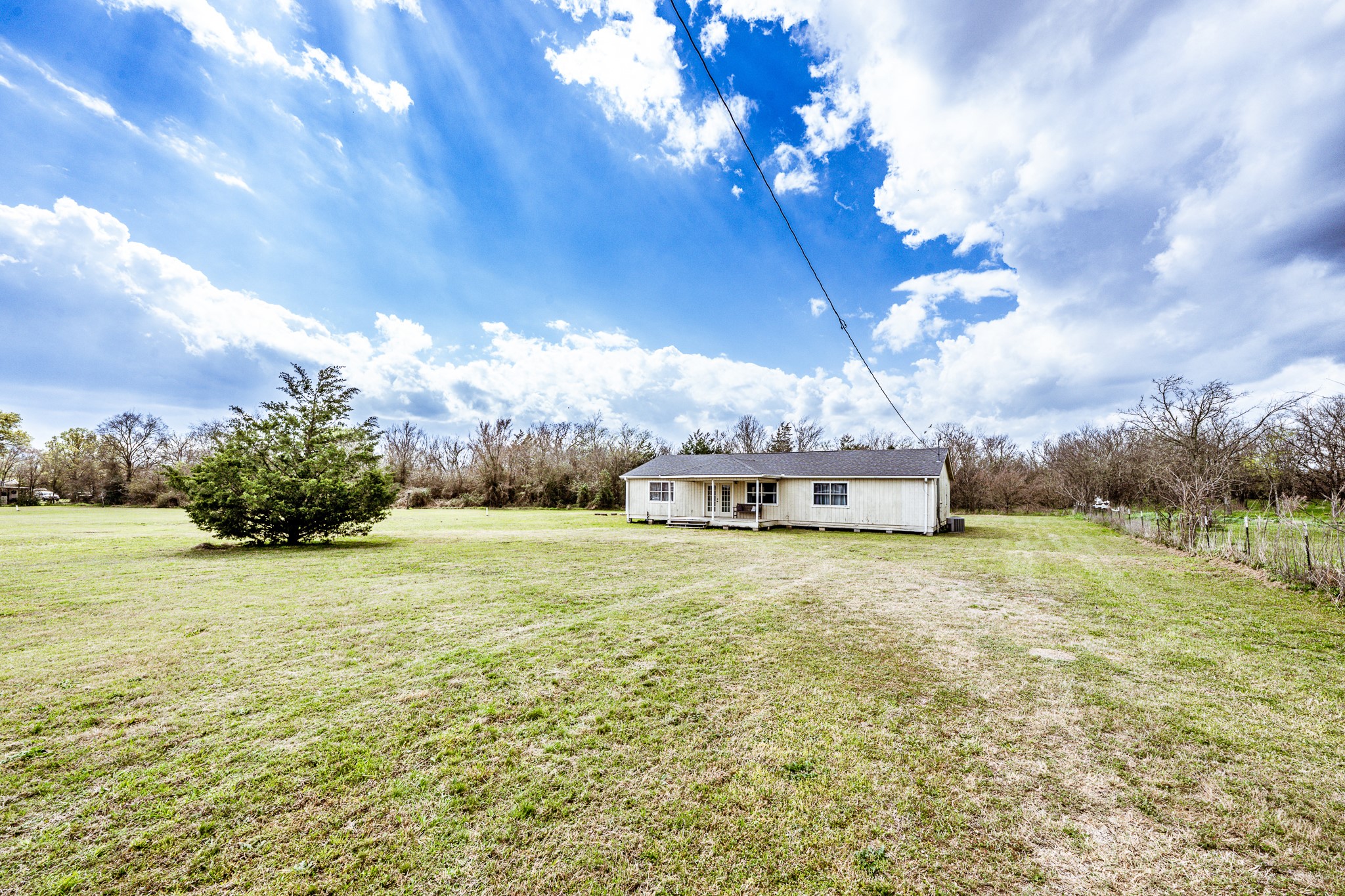 20471 Roy Hall Road Bedias, TX 77831 - Photo 2 of 24 a house with yard in front of it