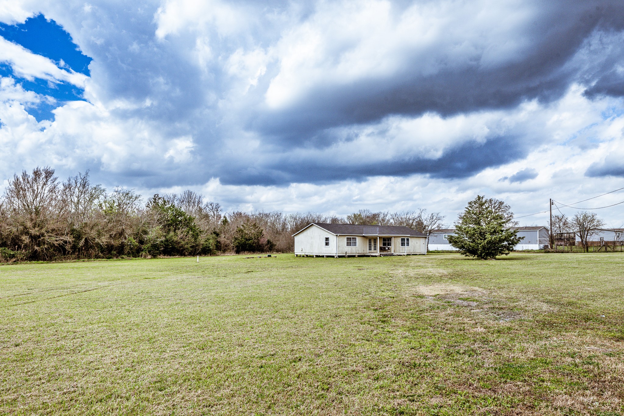20471 Roy Hall Road Bedias, TX 77831 - Photo 22 of 24 a view of a lake with houses in back