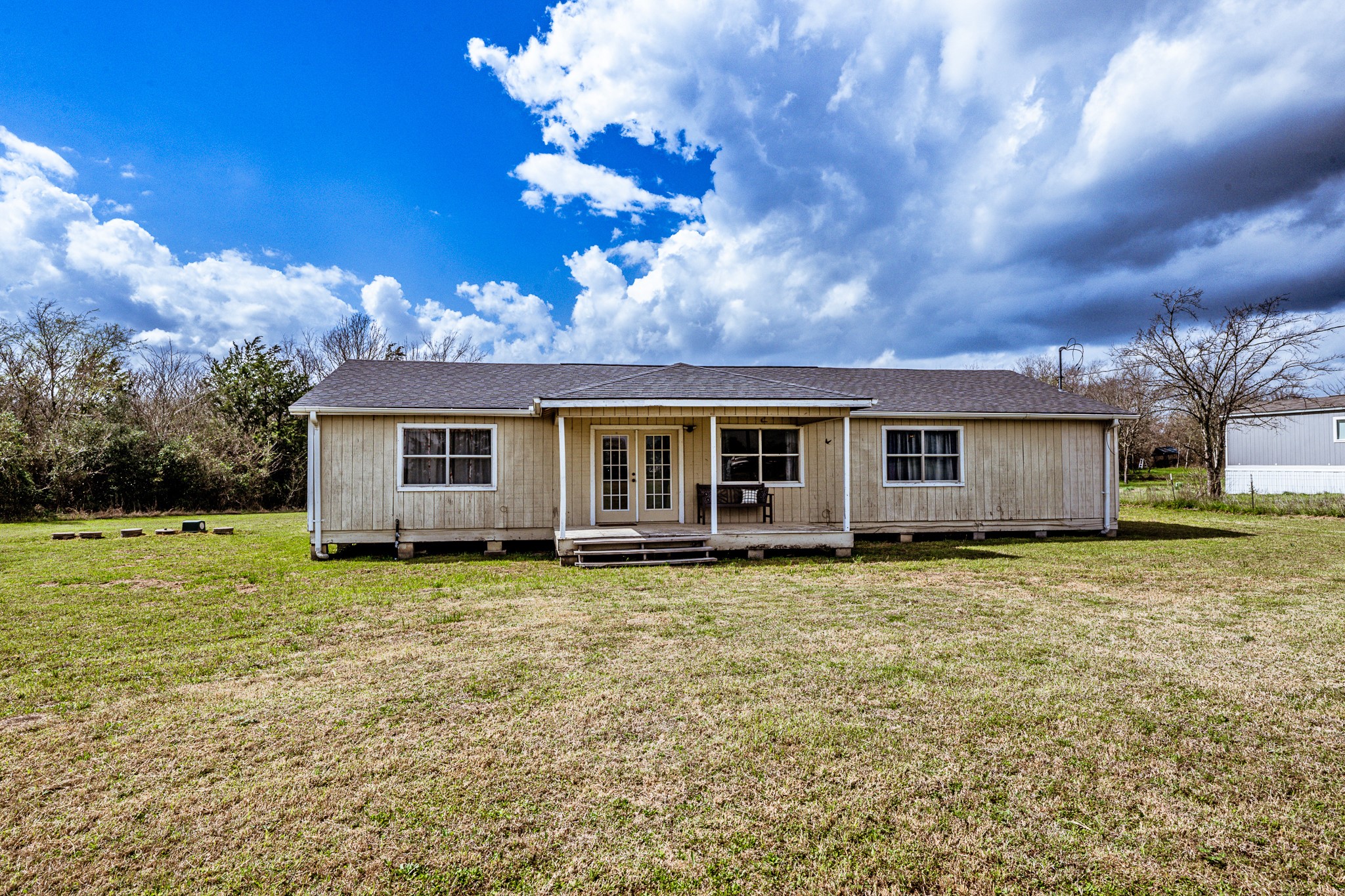20471 Roy Hall Road Bedias, TX 77831 - Photo 3 of 24 a view of a house with a backyard