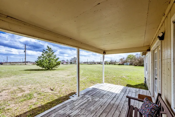 a view of a room with wooden floor and a yard
