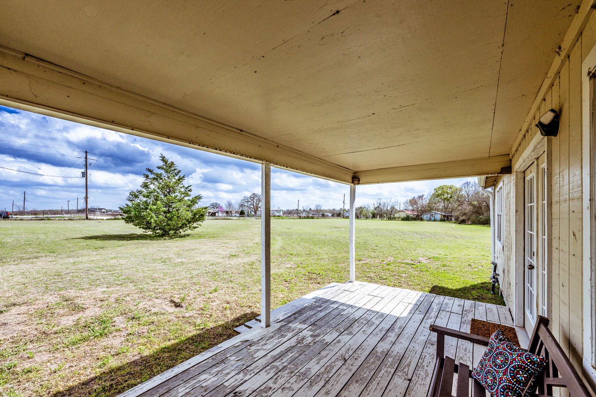 20471 Roy Hall Road Bedias, TX 77831 - Photo 4 of 24 a view of a room with wooden floor and a yard