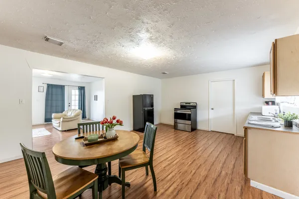 a view of a dining room with furniture and wooden floor