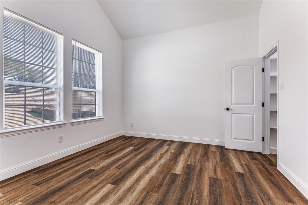 2612 Burchill Road Fort Worth, TX 76105 - Photo 14 of 25 a view of a room with wooden floor and windows
