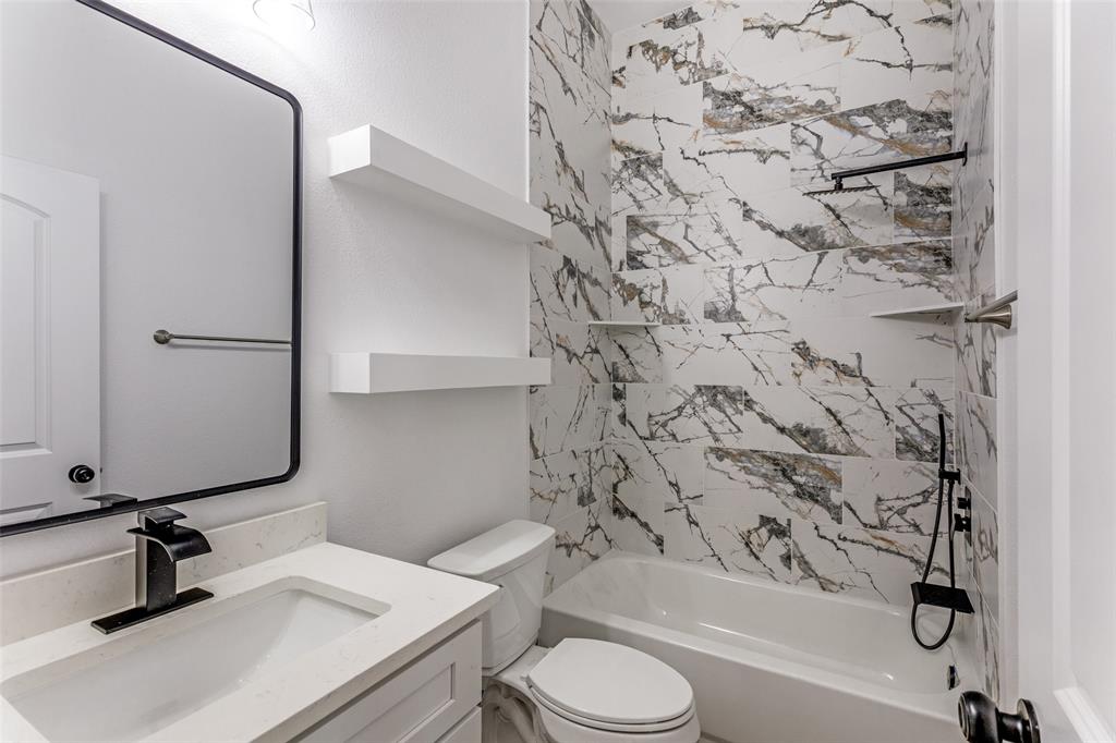 2612 Burchill Road Fort Worth, TX 76105 - Photo 16 of 25 a bathroom with a sink toilet and shower