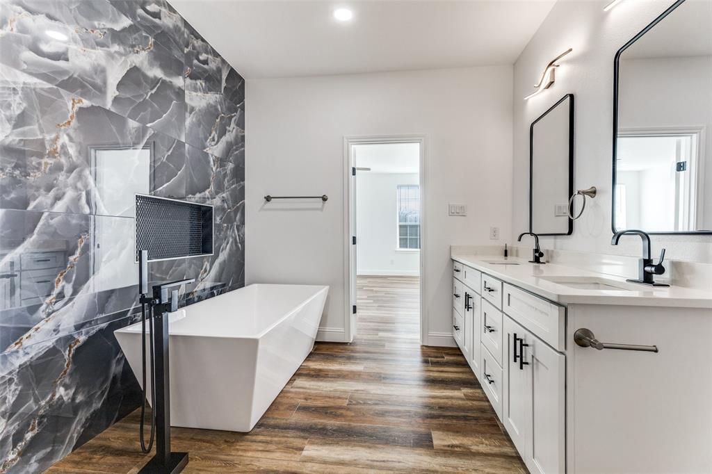 2612 Burchill Road Fort Worth, TX 76105 - Photo 18 of 25 a bathroom with a double vanity sink and mirror