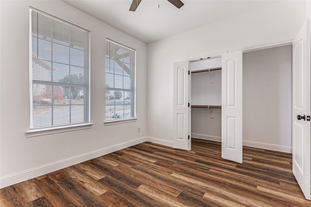 2612 Burchill Road Fort Worth, TX 76105 - Photo 20 of 25 a view of an empty room with wooden floor and a window