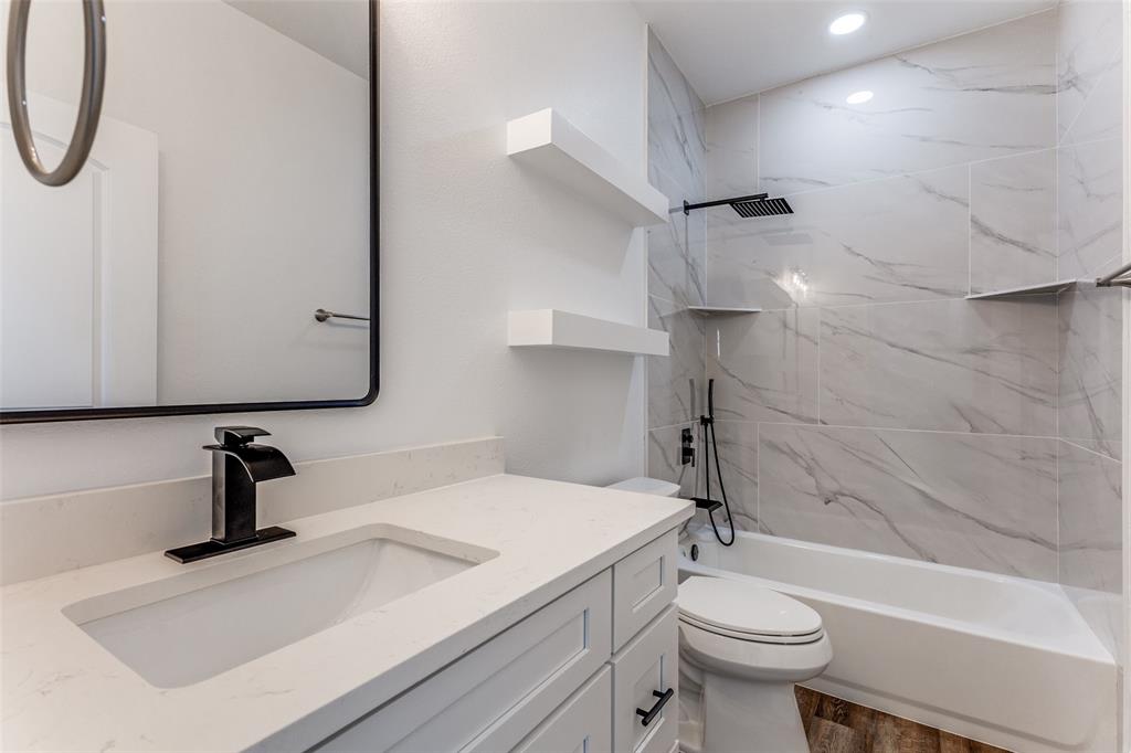 2612 Burchill Road Fort Worth, TX 76105 - Photo 21 of 25 a bathroom with a sink a toilet and a shower