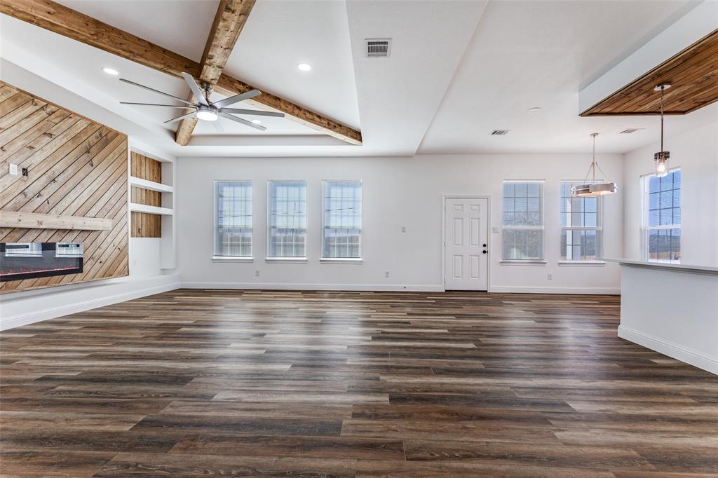 2612 Burchill Road Fort Worth, TX 76105 - Photo 3 of 25 a view of an empty room with wooden floor and a window