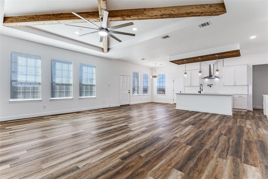 2612 Burchill Road Fort Worth, TX 76105 - Photo 4 of 25 a view of empty room with wooden floor and fan
