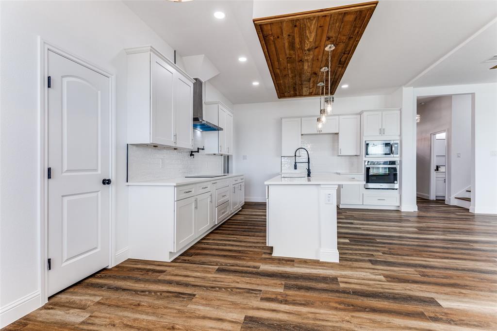 2612 Burchill Road Fort Worth, TX 76105 - Photo 7 of 25 a view of kitchen with stainless steel appliances cabinets and wooden floor