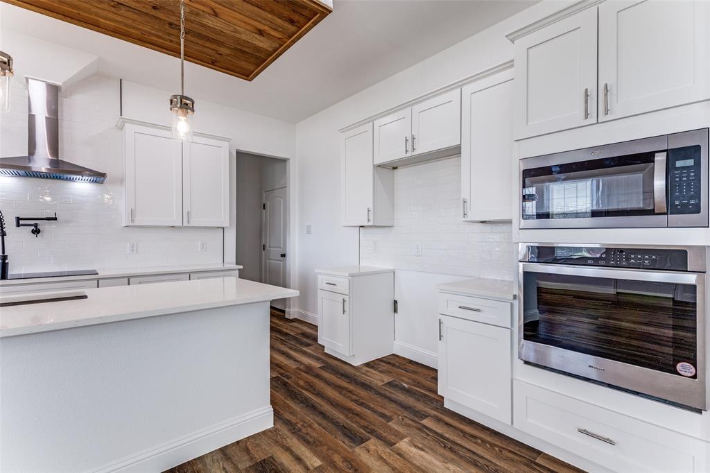 2612 Burchill Road Fort Worth, TX 76105 - Photo 9 of 25 a kitchen with cabinets appliances and a wooden floor