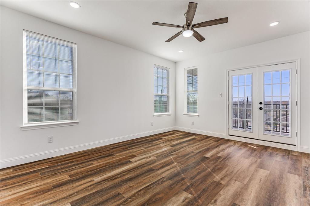 2612 Burchill Road Fort Worth, TX 76105 - Photo 10 of 25 a view of an empty room with a window and wooden floor