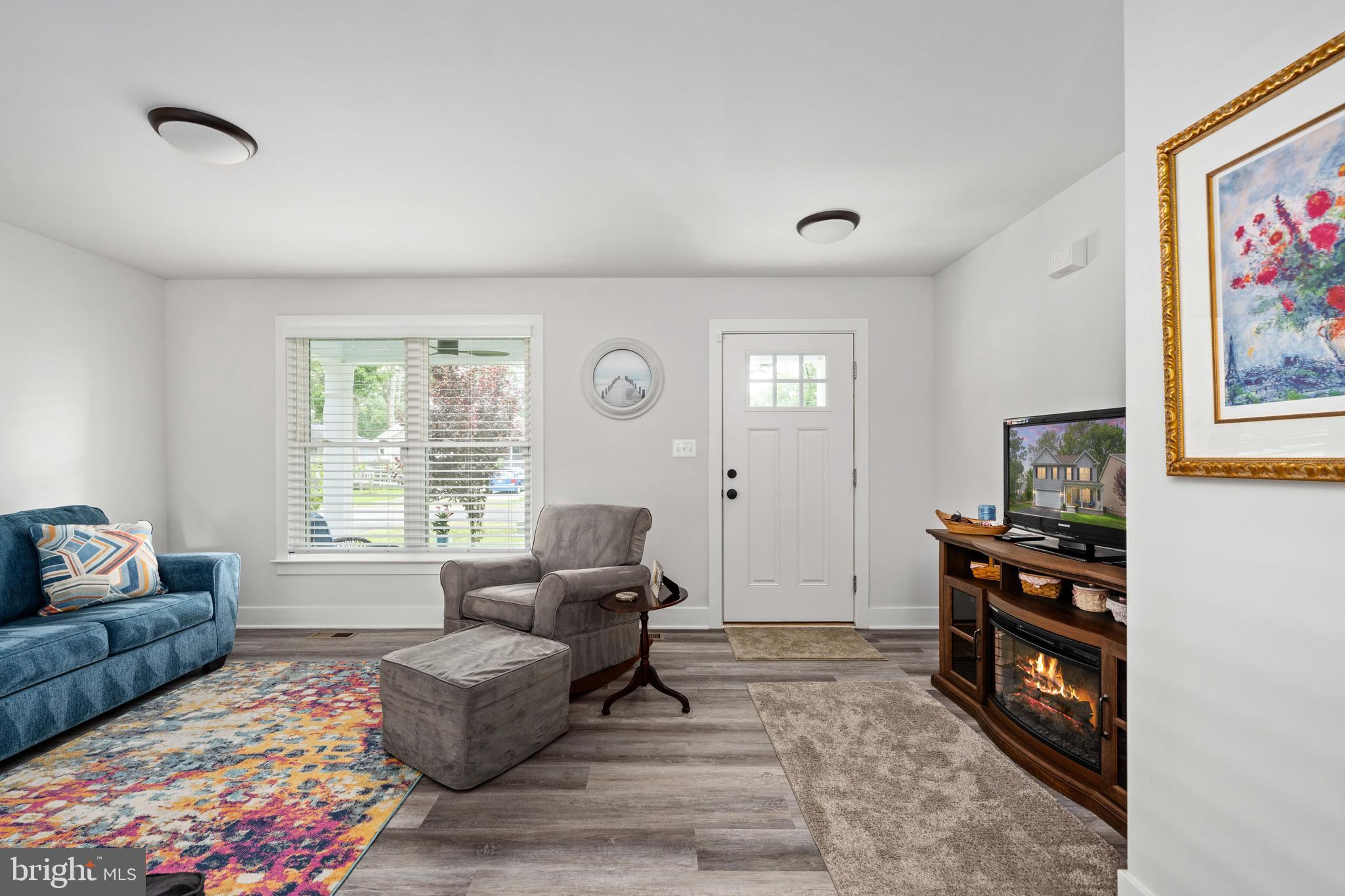 133 7th Street Colonial Beach, VA 22443 - Photo 18 of 72 a living room with furniture and a flat screen tv