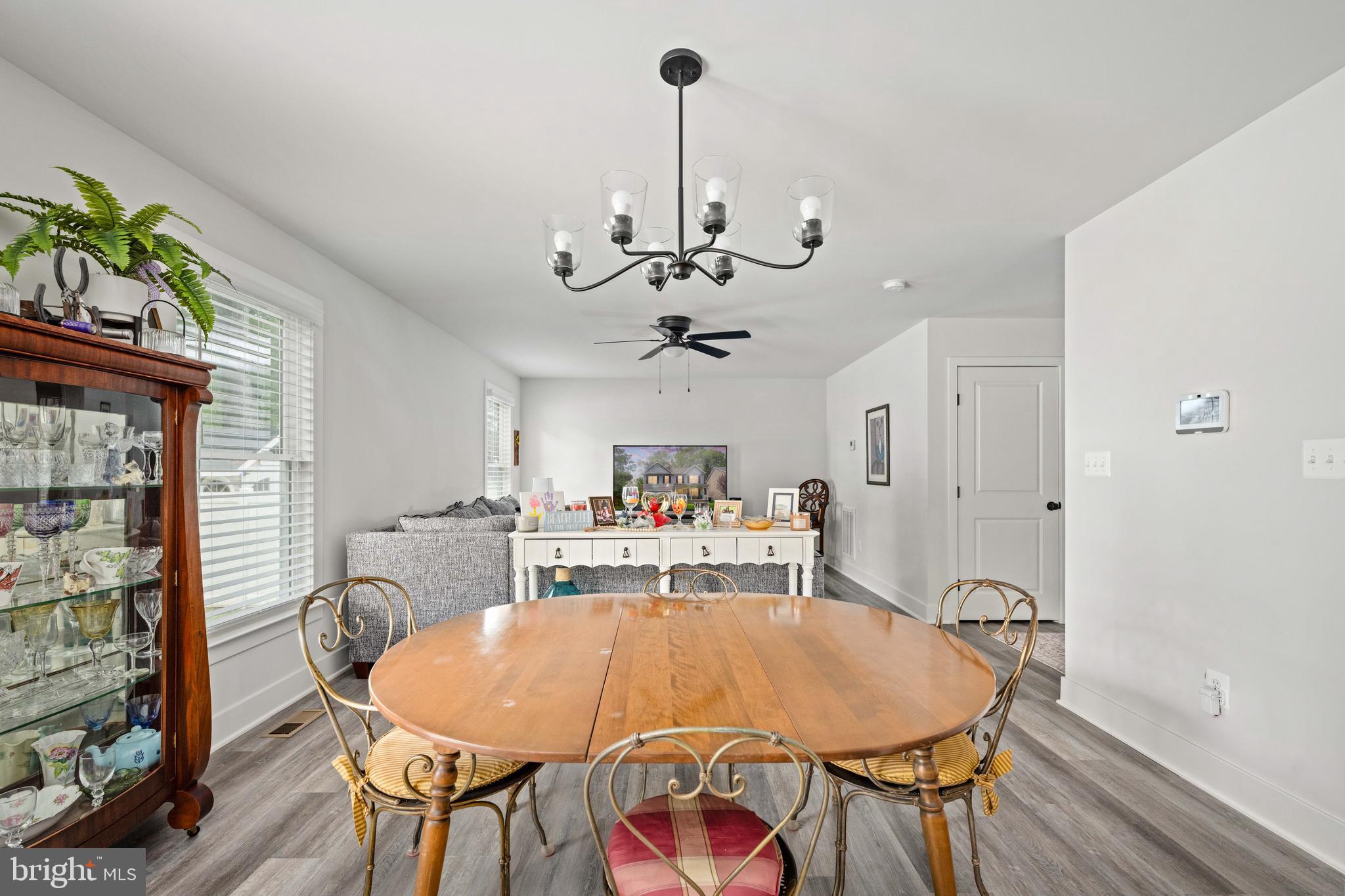 133 7th Street Colonial Beach, VA 22443 - Photo 21 of 72 a dining room with furniture a chandelier and wooden floor