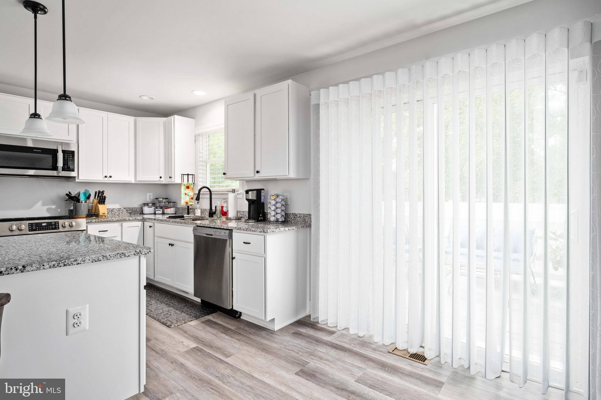 133 7th Street Colonial Beach, VA 22443 - Photo 24 of 72 a kitchen with a white cabinets and window