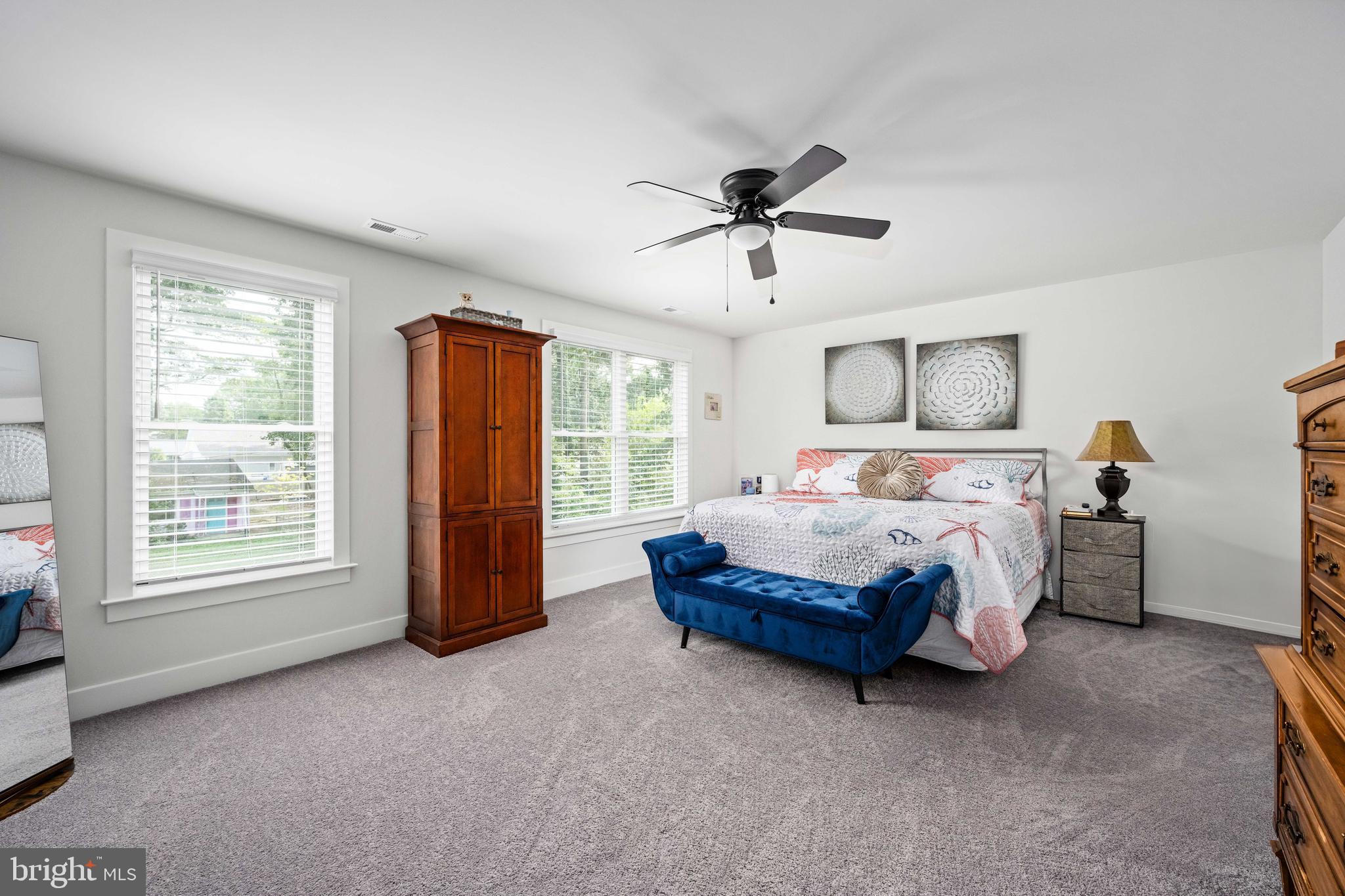 133 7th Street Colonial Beach, VA 22443 - Photo 35 of 72 a spacious bedroom with a bed a chandelier and a window