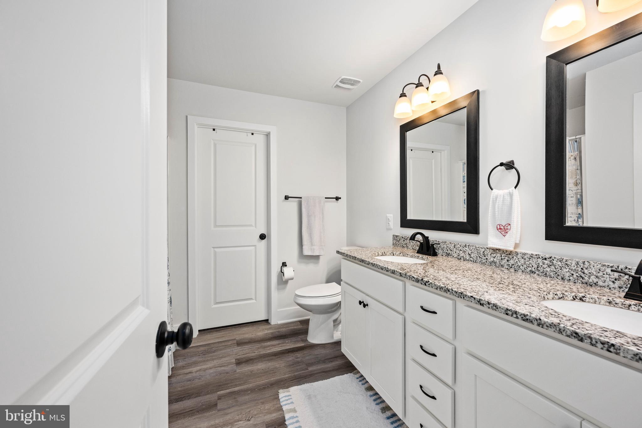 133 7th Street Colonial Beach, VA 22443 - Photo 37 of 72 a bathroom with a granite countertop sink and a mirror