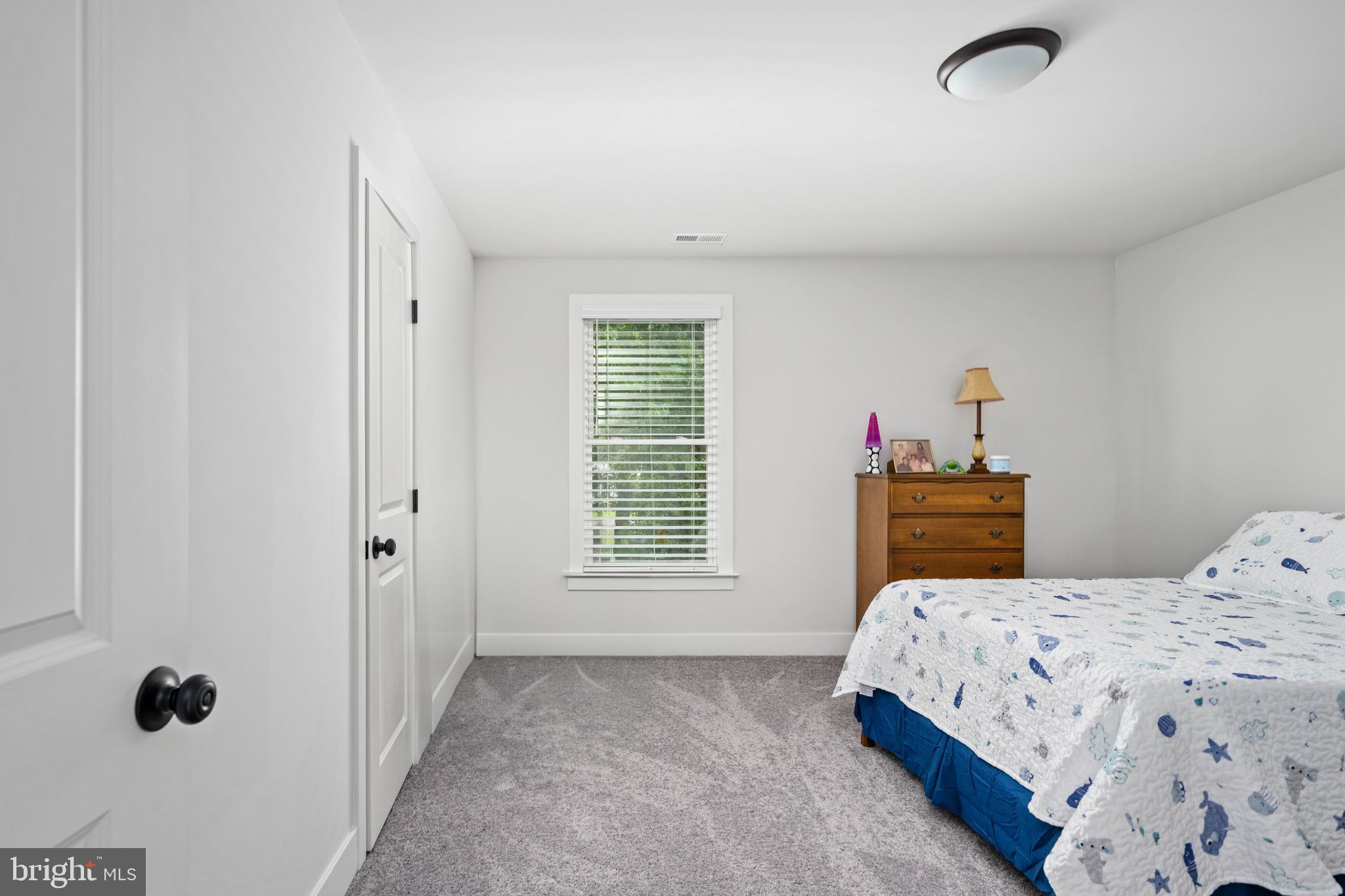 133 7th Street Colonial Beach, VA 22443 - Photo 42 of 72 a bedroom with a bed and a window