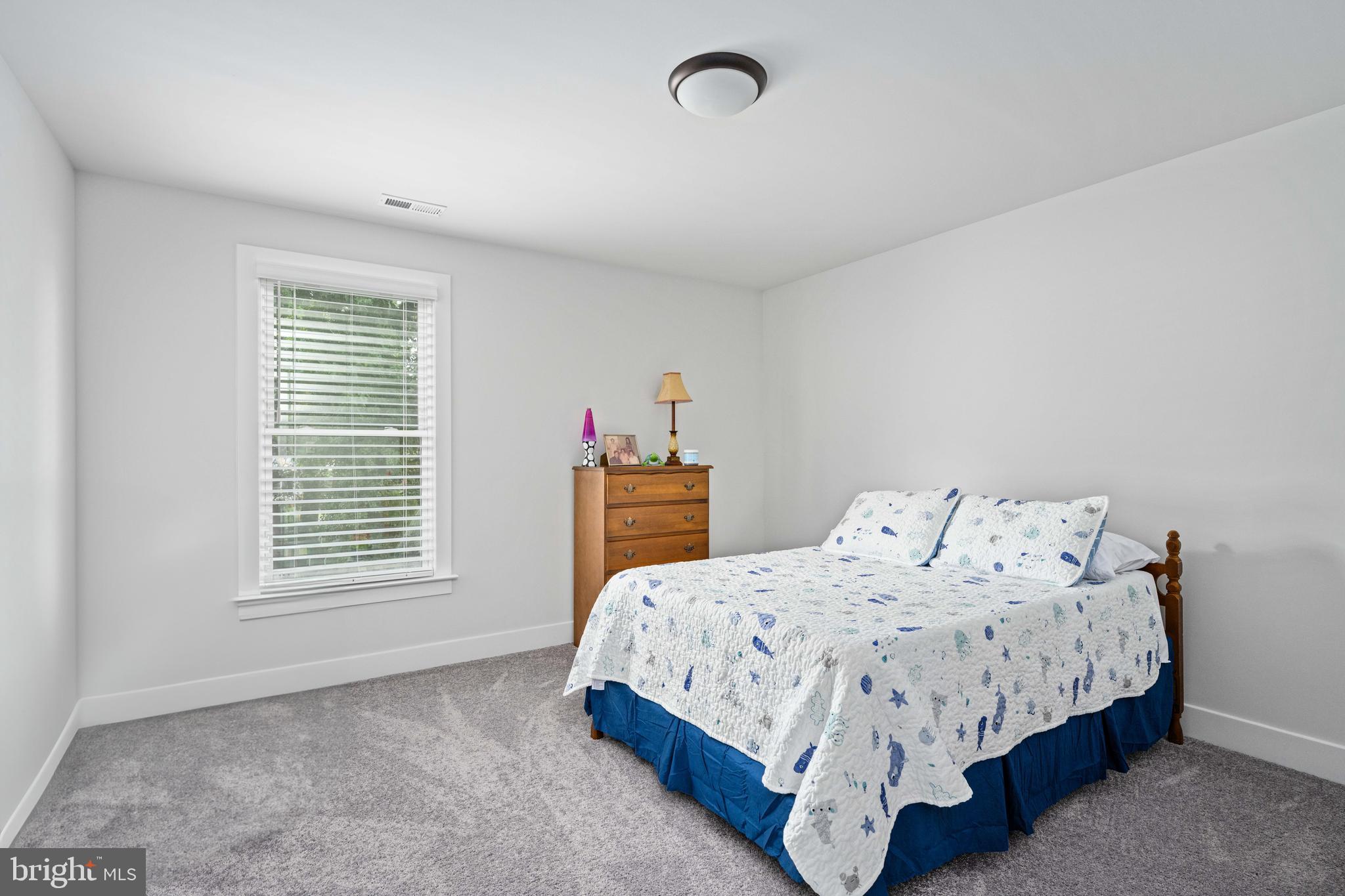 133 7th Street Colonial Beach, VA 22443 - Photo 43 of 72 a bedroom with a bed and a window