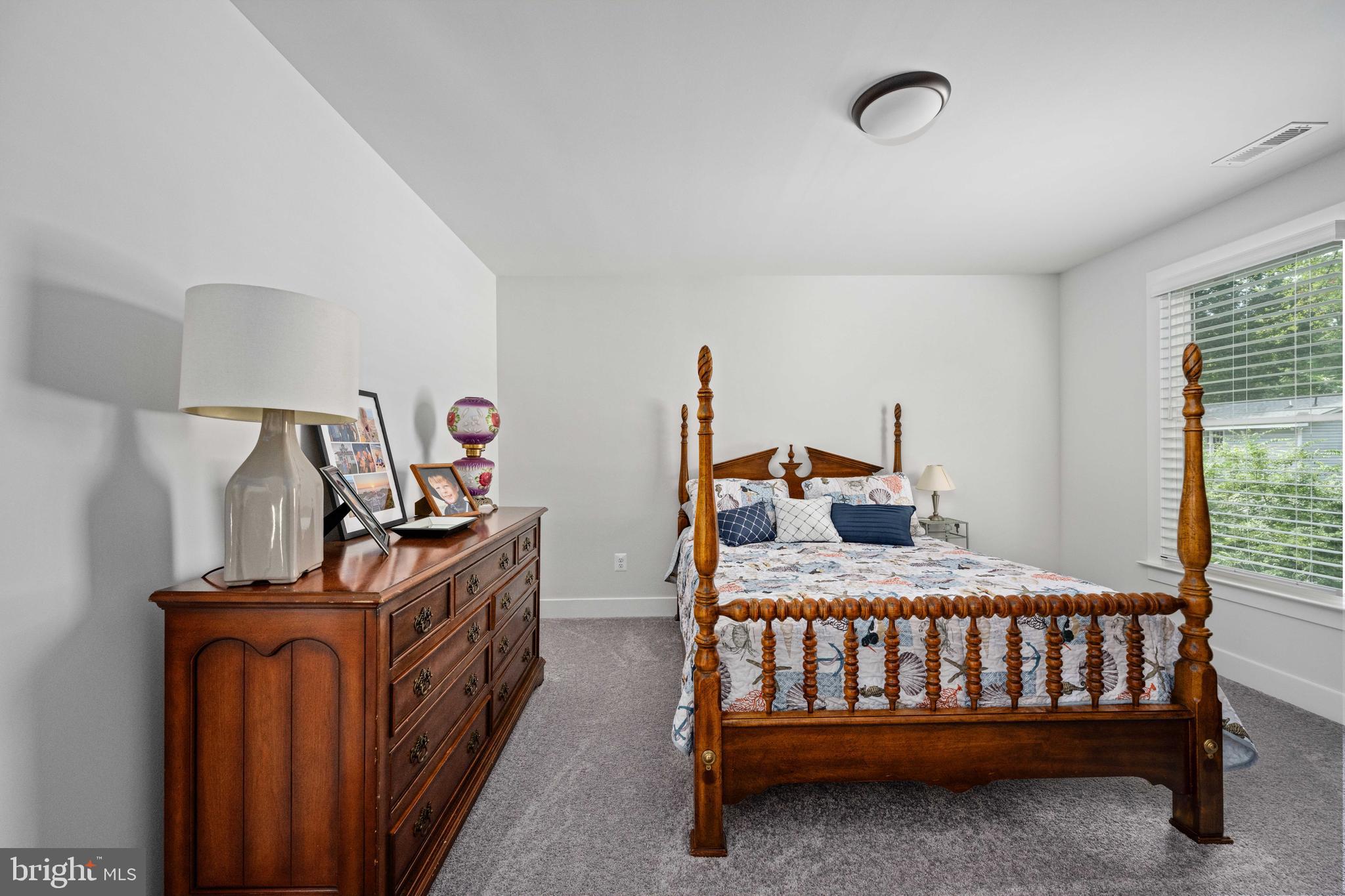133 7th Street Colonial Beach, VA 22443 - Photo 45 of 72 a bedroom with a bed and a chandelier