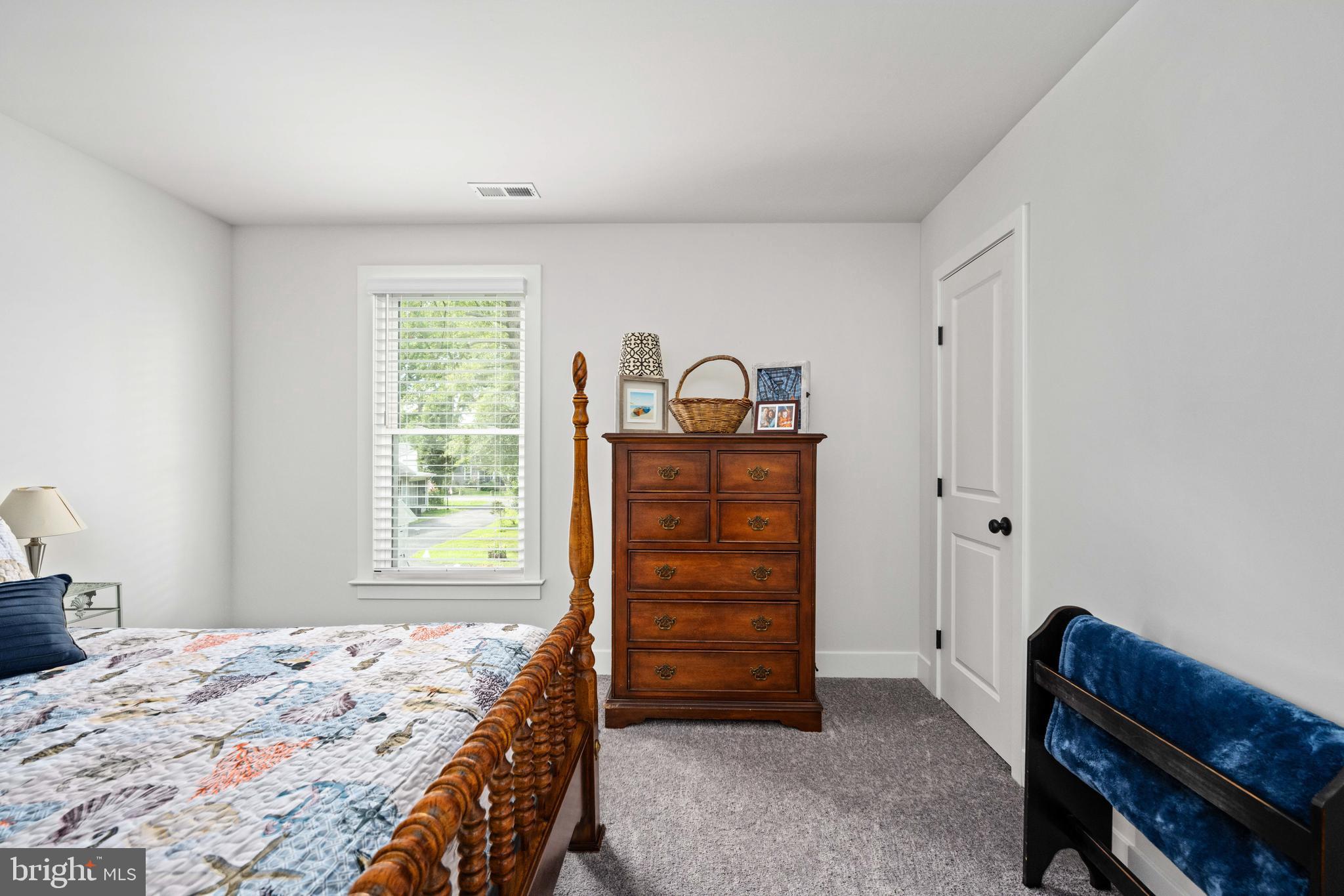 133 7th Street Colonial Beach, VA 22443 - Photo 46 of 72 a bedroom with a bed and a window