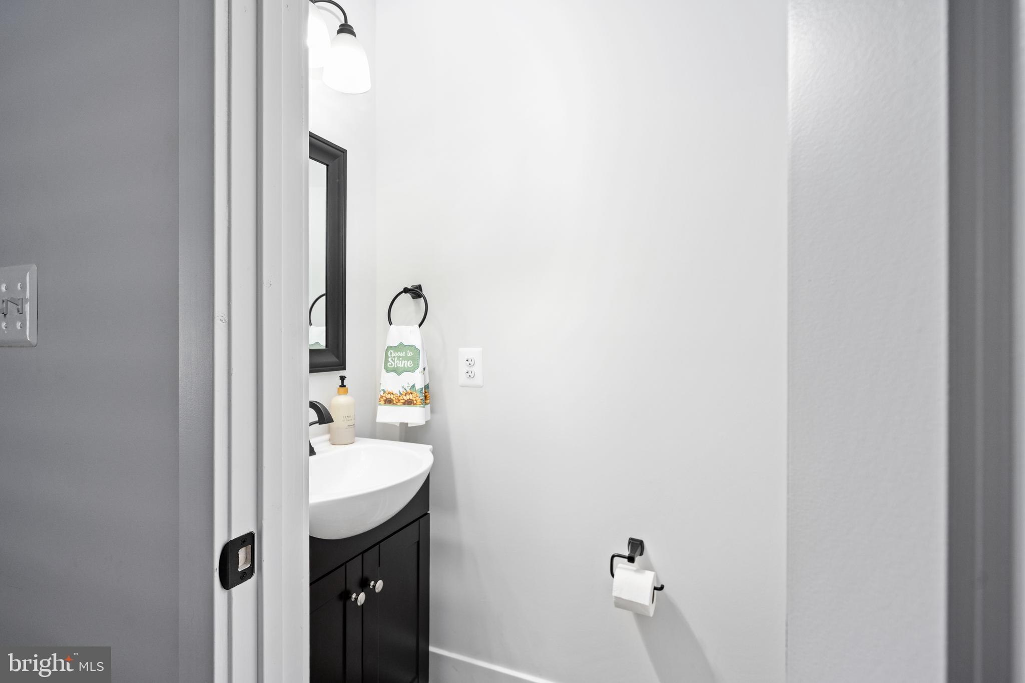 133 7th Street Colonial Beach, VA 22443 - Photo 55 of 72 a bathroom with a sink and mirror