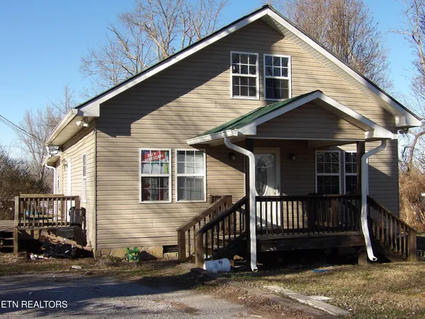 a view of a house with wooden fence