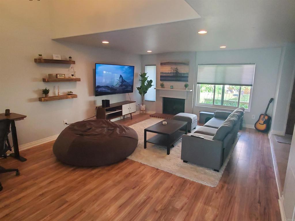 1759 Edgefield Lane Encinitas, CA 92024 - Photo 3 of 10 a living room with furniture a fireplace and a flat screen tv