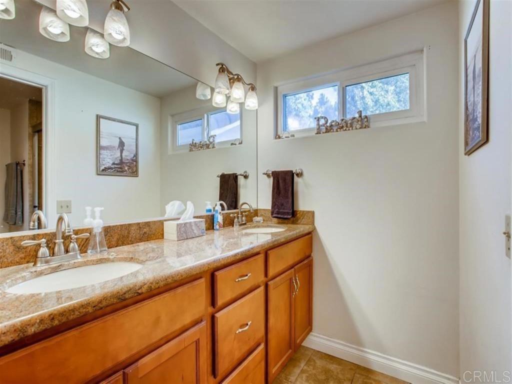 1759 Edgefield Lane Encinitas, CA 92024 - Photo 6 of 10 a bathroom with a sink a mirror and a window