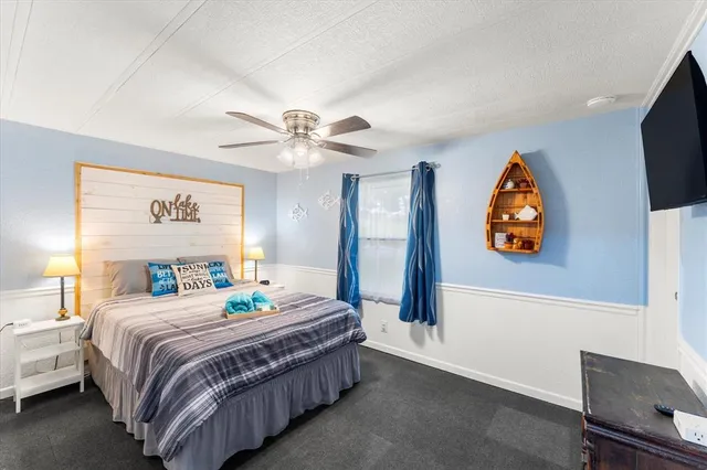 a bedroom with a bed and a chandelier