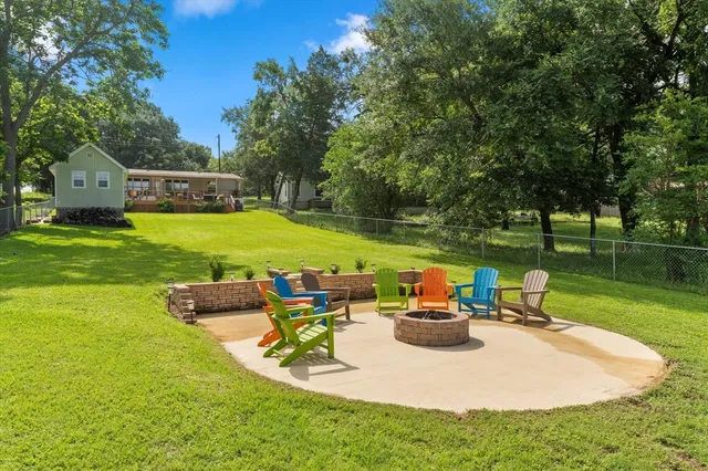 a view of a house with garden and a chairs