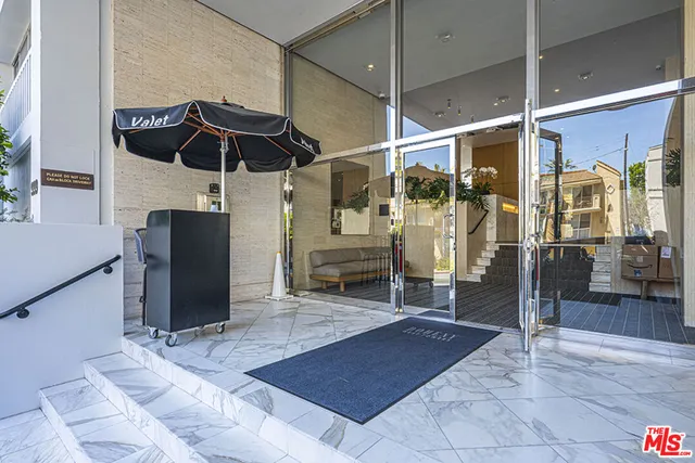 a view of a porch with a table and chairs