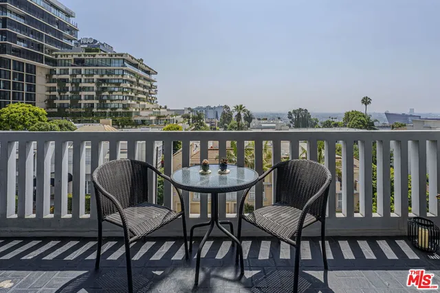 a view of a chairs and table on the deck