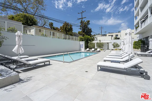 a view of a patio with a table and chairs and potted plants